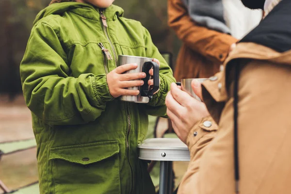 Father and son with hot drinks outdoors — Stock Photo