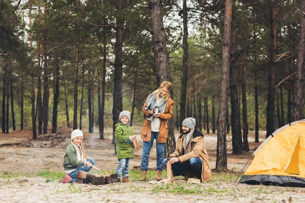 Family making campfire together — Stock Photo