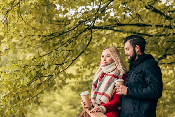 Couple drinking coffee in park — Stock Photo