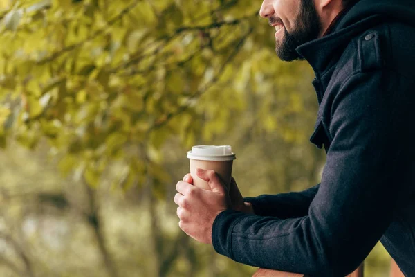 Man with paper cup in park — Stock Photo