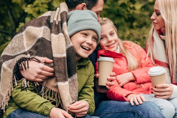 Family with paper cups in park — Stock Photo