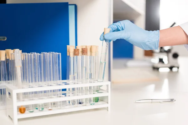 Scientist working with test tubes — Stock Photo