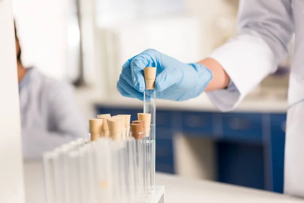 Scientist working with test tubes — Stock Photo