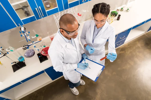 Scientists examining test tube — Stock Photo