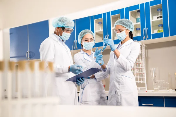 Scientists working with test tubes — Stock Photo