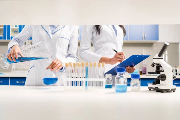 Scientists working with reagents — Stock Photo