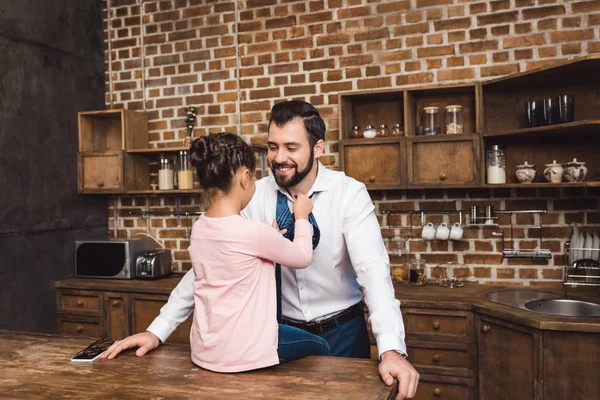 Daughter tying up necktie for father — Stock Photo