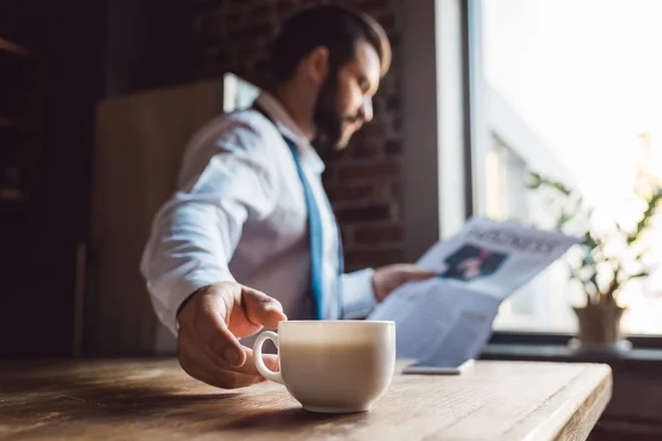 Businessman reading newspaper — Stock Photo