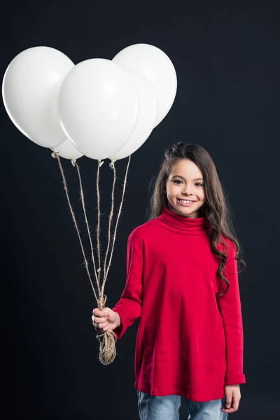 Kid holding bundle of balloons — Stock Photo