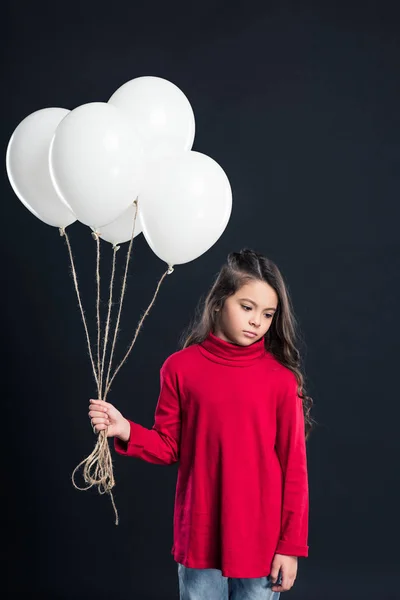 Kid holding bundle of balloons — Stock Photo