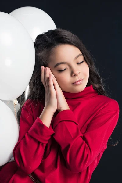 Kid sleeping on white balloons — Stock Photo