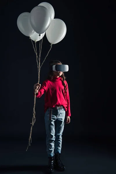 Kid in VR headset holding balloons — Stock Photo