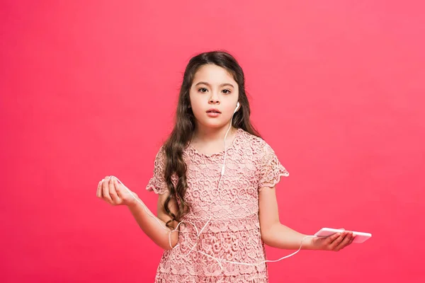 Kid with smartphone and earphones — Stock Photo