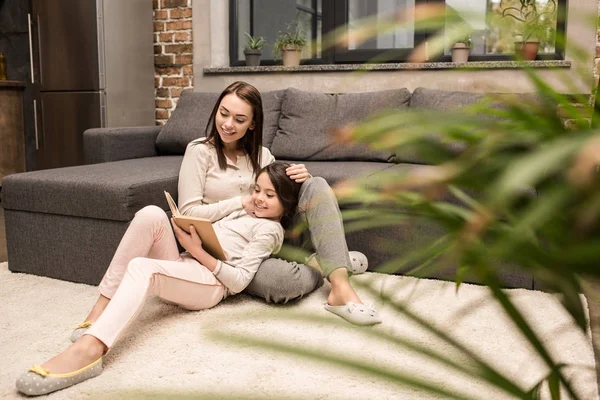 Family reading book together — Stock Photo