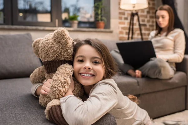 Kid playing with teddy bear — Stock Photo