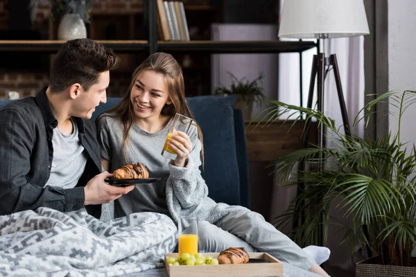 Pareja desayunando en la cama por la mañana - foto de stock