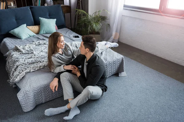 Attraktives Paar schaut einander im Schlafzimmer an — Stockfoto