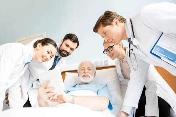 Artsen en senior patiënt — Stockfoto