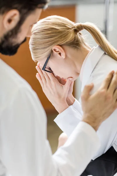 Doctor soothing upset colleague — Stock Photo, Image