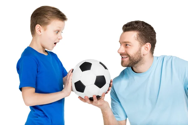 father and son playing soccer 