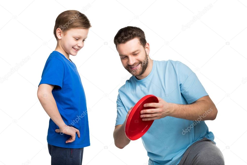 Father and son playing with frisbee