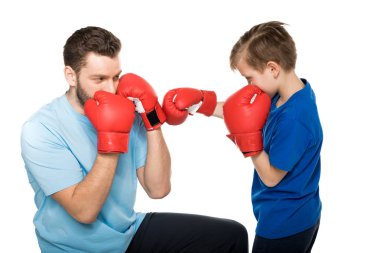 father with son during boxing training clipart