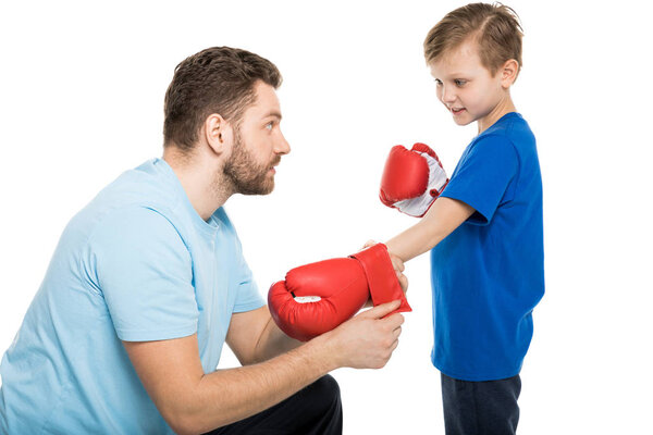 father with son during boxing training