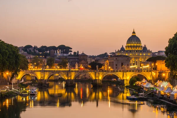 Image of River Tiber, including: Ponte Sant Angelo and St. Peter's Basilica in the background. Rome - Italy. Royalty Free Stock Photos