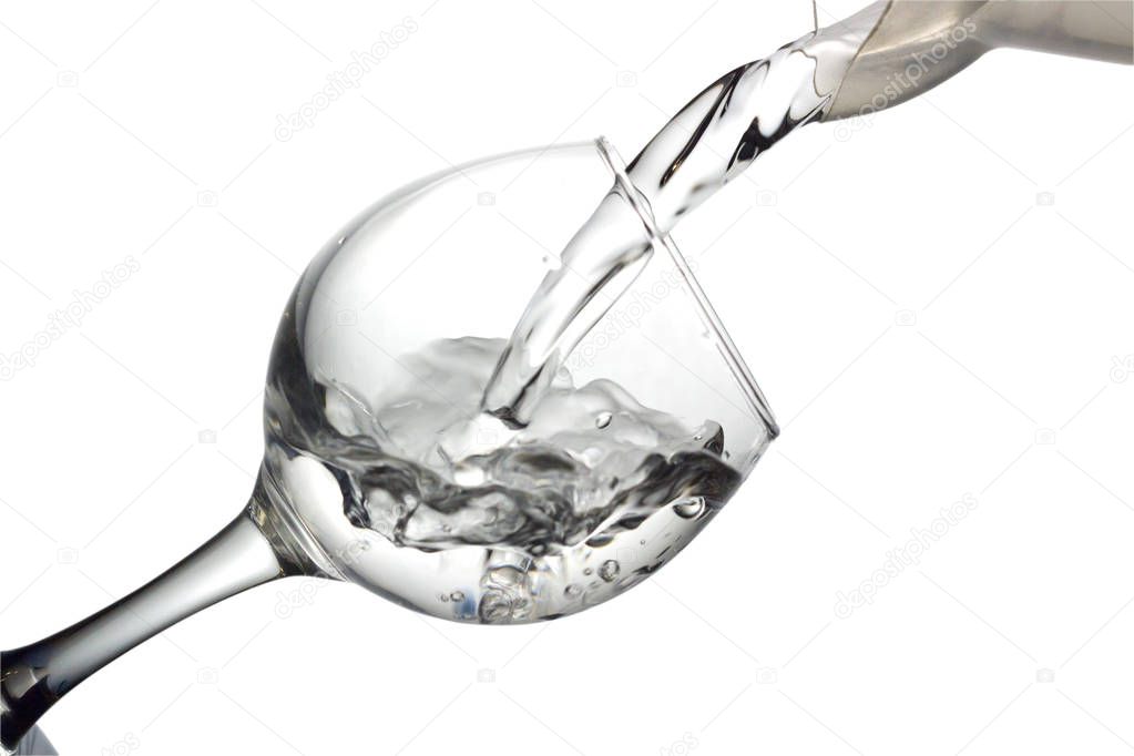 Water pours into a glass on a white background, monochrome image