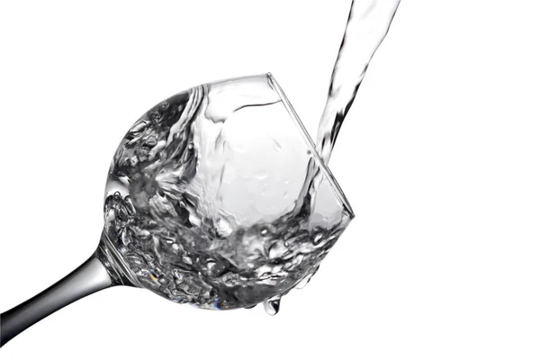 Water pours into a glass on a white background, monochrome image — Stock Photo, Image