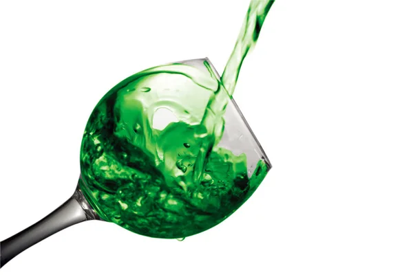 Green water pours into a glass on a white background — Stock Photo, Image