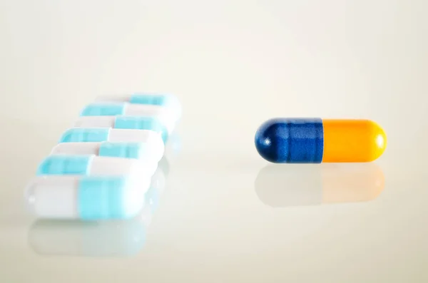 One yellow blue medical capsule — Stock Photo, Image