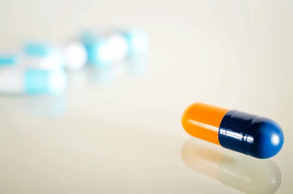 One yellow blue medical capsule — Stock Photo, Image