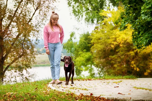 smiling girl relaxing with dog.