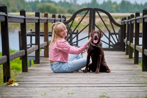 smiling girl relaxing with dog
