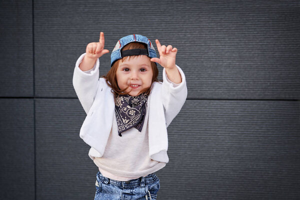 fashion baby girl hip hop.a little girl in a baseball cap.
