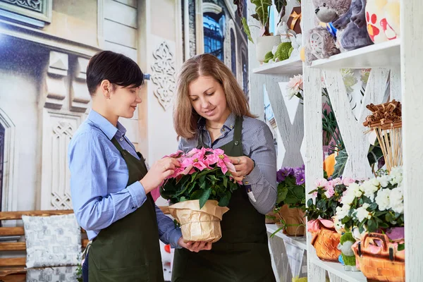 small flower business. Women working in flower shop.