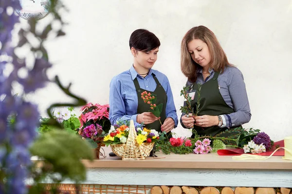 Small flower business. Women working in flower shop.