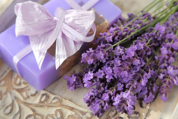 Bouquet of lavender and lavender soap on a wooden background.