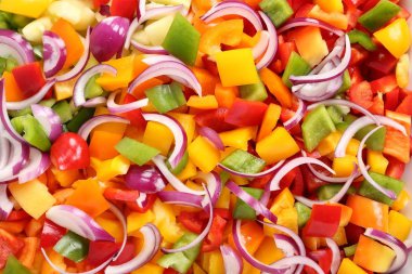 Bir seramik tabak içinde renkli, doğranmış biber.