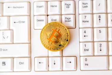 Cryptocurrency para bitcoin beyaz bir klavye üzerinde yatıyor