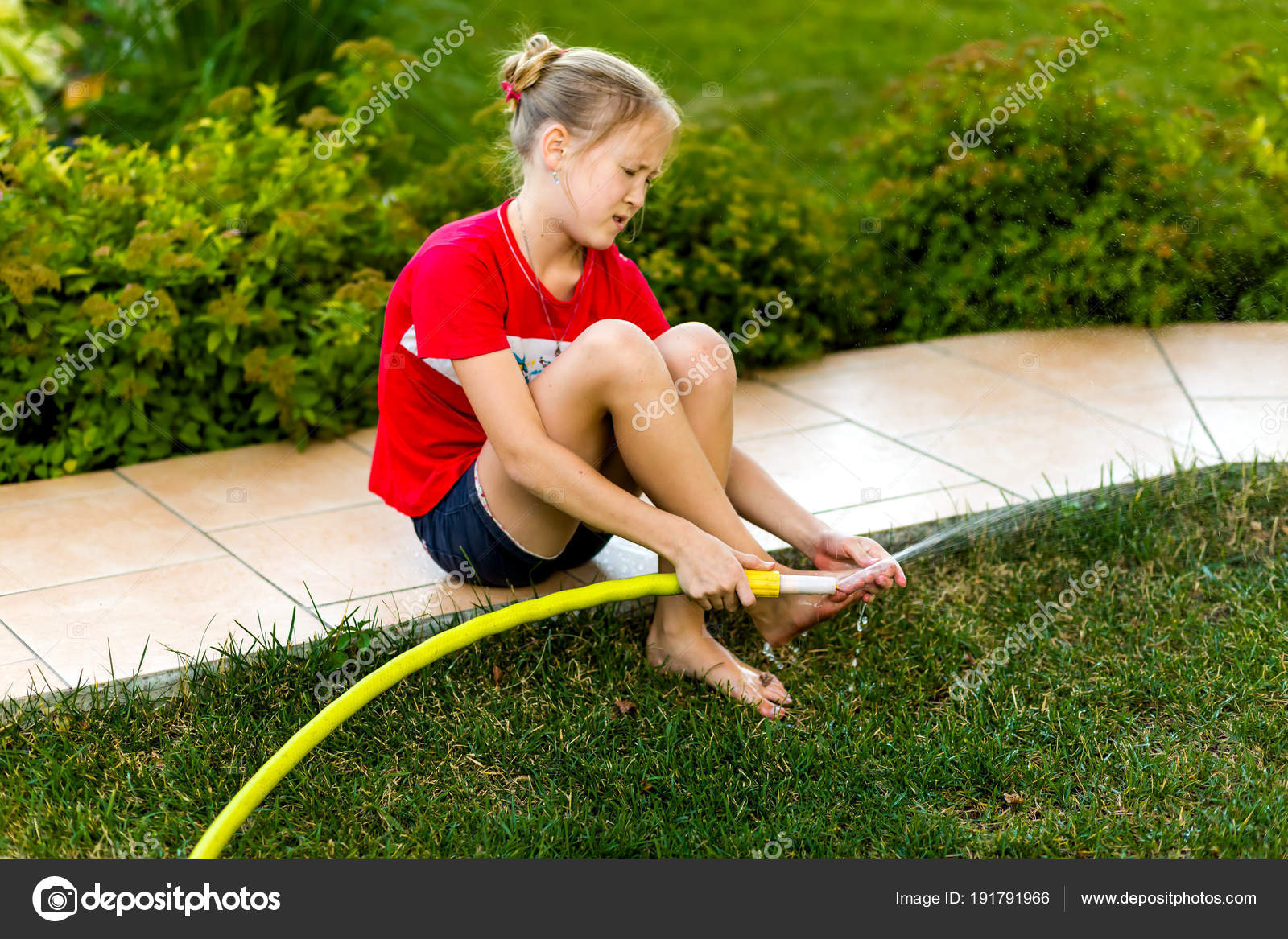 Girl Washes Her Feet With Water From A Hose - Stock Photo © Most55.