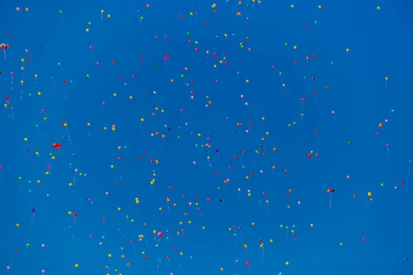 Globos multicolores vuelan en el cielo azul — Foto de Stock