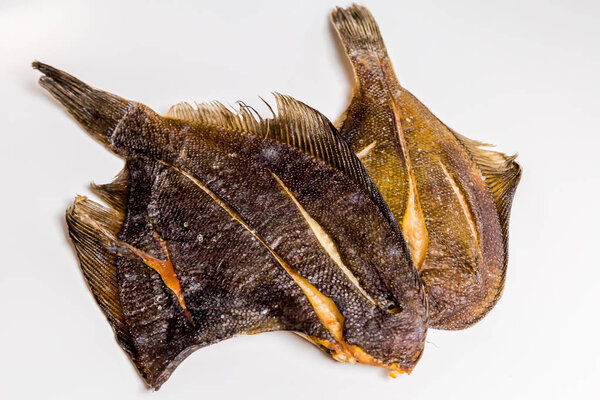 dried flounder lie on a white background