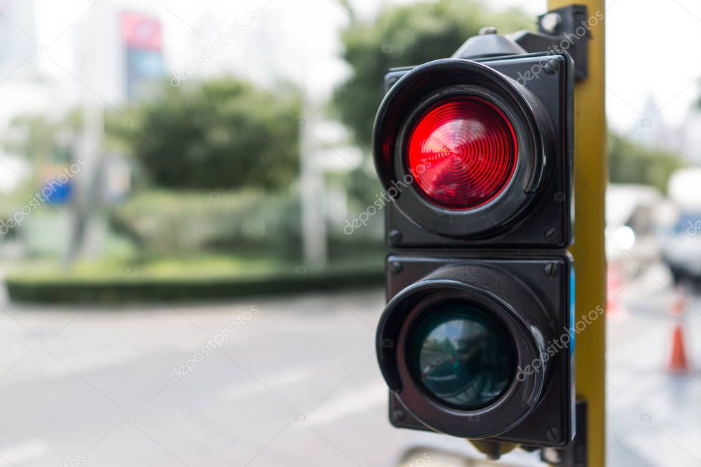 close up traffic light stop red and green on day 