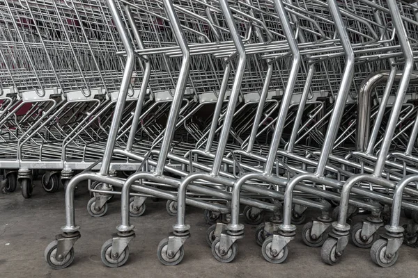 group of shopping carts, wheels in front of supermarket