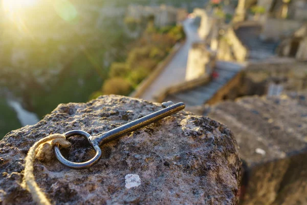 Vintage key on the stone with sun light in the morning as key to — Stock Photo, Image