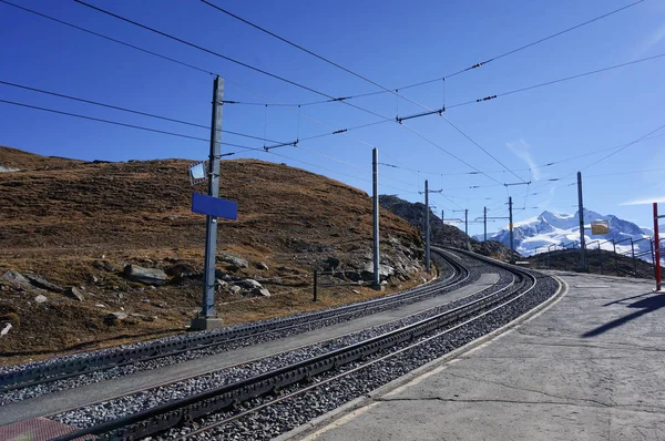 Beautiful scenic train railway transportation on alp with snow m