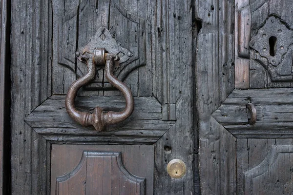 Выдержанные деревянные двери с винтажной металлической дверью стучать в Matera, су — стоковое фото