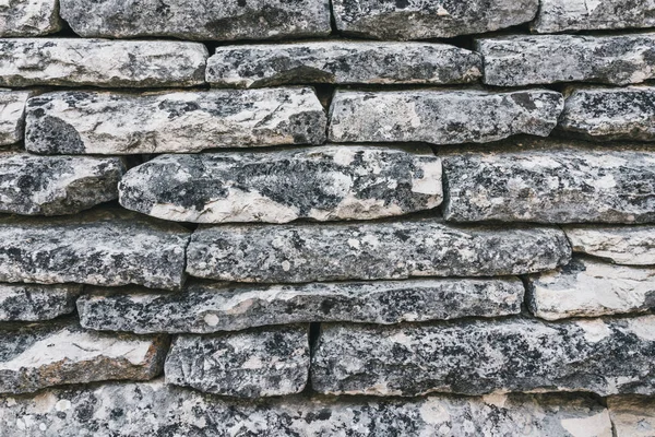 rustic ancient handcraft tile stack stone wall as background in
